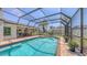 Large screened-in pool with attached patio and outdoor dining area for entertaining at 4308 Kingston Loop, Sarasota, FL 34238