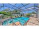 Inviting screened-in pool area with brick paving and mature landscaping at 4308 Kingston Loop, Sarasota, FL 34238