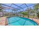 Beautiful screened-in pool with brick surround and well-maintained landscaping at 4308 Kingston Loop, Sarasota, FL 34238