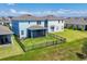 Aerial view of the backyard, with a green lawn, fence, and patio at 4524 Pippin Ln, Lakewood Ranch, FL 34211