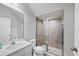 The bathroom features a shower stall, white cabinets, granite countertop, and framed mirror at 4524 Pippin Ln, Lakewood Ranch, FL 34211