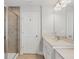 Well-lit bathroom features a single vanity, granite countertops, tile floors, and a shower with glass door at 4524 Pippin Ln, Lakewood Ranch, FL 34211
