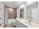 This bathroom has a double sink vanity with tile flooring, quartz countertops and framed mirrors at 4524 Pippin Ln, Lakewood Ranch, FL 34211