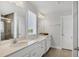 Bright bathroom features double vanity, granite countertops, and a tiled shower providing a luxurious experience at 4524 Pippin Ln, Lakewood Ranch, FL 34211