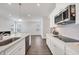 Modern kitchen with white cabinets, stainless steel appliances, and an open layout into the living area at 4524 Pippin Ln, Lakewood Ranch, FL 34211
