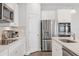 Contemporary kitchen with stainless steel appliances, white cabinets, and a stylish tile backsplash at 4524 Pippin Ln, Lakewood Ranch, FL 34211