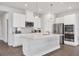 Modern kitchen with stainless steel appliances, white cabinetry, and a large center island at 4524 Pippin Ln, Lakewood Ranch, FL 34211