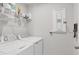 Laundry room with a standard washer, dryer, shelf, and wire shelving units at 4524 Pippin Ln, Lakewood Ranch, FL 34211