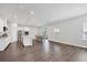 Bright, open living room boasts hardwood floors, stainless steel appliances, a kitchen island, and a dining area at 4524 Pippin Ln, Lakewood Ranch, FL 34211