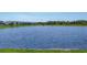 Scenic pond view featuring neighborhood homes in a tranquil community setting at 4524 Pippin Ln, Lakewood Ranch, FL 34211