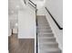 Elegant staircase features wood and iron railing, carpeted steps, and leads to the upper level of the home at 4524 Pippin Ln, Lakewood Ranch, FL 34211