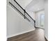 Elegant staircase with dark wood floors and a sleek black railing leading upstairs at 4524 Pippin Ln, Lakewood Ranch, FL 34211