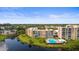 Aerial view of the community with a swimming pool and building near a pond at 4530 Pinebrook Cir # 109, Bradenton, FL 34209