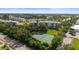 Aerial view showcasing tennis courts, verdant trees, and building at 4530 Pinebrook Cir # 109, Bradenton, FL 34209
