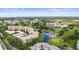 A beautiful aerial view of a condo community with a golf course and pond views on a sunny day at 4530 Pinebrook Cir # 109, Bradenton, FL 34209