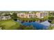 Community aerial view featuring lush landscaping and a scenic pond with golf course at 4530 Pinebrook Cir # 109, Bradenton, FL 34209
