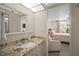 Bathroom featuring granite countertops and a view to the primary bedroom at 4530 Pinebrook Cir # 109, Bradenton, FL 34209
