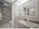 Well-lit bathroom featuring a granite countertop vanity and a modern glass-enclosed shower at 4530 Pinebrook Cir # 109, Bradenton, FL 34209