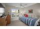 Bedroom with a large window, blue and white striped bed, and a wooden dresser at 4530 Pinebrook Cir # 109, Bradenton, FL 34209