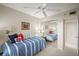 This bedroom features a mirror sliding-door closet and a blue and white striped bed at 4530 Pinebrook Cir # 109, Bradenton, FL 34209