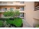 Condo entrance with lush landscaping at 4530 Pinebrook Cir # 109, Bradenton, FL 34209