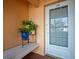 Close-up view of front porch with bench, plants and front door at 4530 Pinebrook Cir # 109, Bradenton, FL 34209