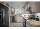 Well-equipped kitchen featuring stainless steel appliances and stylish wood-look cabinets at 4530 Pinebrook Cir # 109, Bradenton, FL 34209
