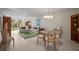 Bright living room with view to lanai with tile floors, comfortable furniture, and elegant chandelier at 4530 Pinebrook Cir # 109, Bradenton, FL 34209