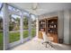 Bright sunroom with tiled floors, a ceiling fan, and views of the green outdoors at 4530 Pinebrook Cir # 109, Bradenton, FL 34209