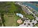 Aerial view showcases community pool, playground, and a large retention pond in the neighborhood at 4739 Reisswood Loop, Palmetto, FL 34221