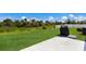 Spacious backyard featuring lush green grass, barbecue, and a tranquil natural backdrop at 4739 Reisswood Loop, Palmetto, FL 34221