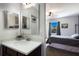 Bathroom features a modern vanity, sink, mirror, and fixtures, conveniently located next to the bedroom at 4739 Reisswood Loop, Palmetto, FL 34221