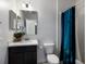Bathroom featuring vanity with storage, lighting, toilet, and decorative shower curtain at 4739 Reisswood Loop, Palmetto, FL 34221