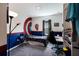 The spacious bedroom features a custom Captain America wall design, a window, desk, and plenty of space at 4739 Reisswood Loop, Palmetto, FL 34221
