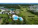 Community pool with a splash pad, lush tropical landscaping, and mature trees at 4739 Reisswood Loop, Palmetto, FL 34221