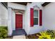 Inviting front entry with a striking red door and modern architectural details that welcomes you home at 4739 Reisswood Loop, Palmetto, FL 34221