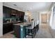 Modern kitchen with a large island, stainless steel appliances, and stylish seating for casual dining at 4739 Reisswood Loop, Palmetto, FL 34221