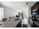 Stylish kitchen with granite countertops, stainless steel appliances, and an open view to the living area at 4739 Reisswood Loop, Palmetto, FL 34221
