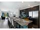 Spacious kitchen with a granite island, stainless steel appliances, and a view of the living room area at 4739 Reisswood Loop, Palmetto, FL 34221