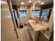 Bathroom with tiled floors, a spacious vanity, and a shower at 5301 Algeria Ct, Bradenton, FL 34207