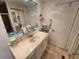 Full bathroom with tiled floor, single sink vanity, mirror, and walk-in shower at 5301 Algeria Ct, Bradenton, FL 34207