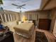 Bedroom featuring a ceiling fan, paneled walls, neutral decor, and a hardwood floor at 5301 Algeria Ct, Bradenton, FL 34207