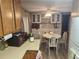 Open eat-in kitchen with bright cabinetry, tile backsplash, and modern appliances at 5301 Algeria Ct, Bradenton, FL 34207
