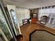 Bright living room with ample natural light, a display cabinet, and wood-look flooring at 5301 Algeria Ct, Bradenton, FL 34207