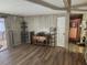 Living room with hardwood floors, light-color paneling, shelving, and entertainment center at 5301 Algeria Ct, Bradenton, FL 34207