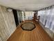 Spacious sunroom featuring wood-look flooring, sheer curtains, and natural light at 5301 Algeria Ct, Bradenton, FL 34207