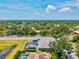 An aerial view showcases the home's location, pool, and expansive lush greenery surrounding the property at 5373 Anthony Ln, Sarasota, FL 34233