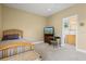 Comfortable bedroom with a twin bed and an adjacent bathroom, providing convenience and privacy at 5373 Anthony Ln, Sarasota, FL 34233