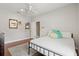 Bright bedroom features wood floors, a ceiling fan, and ample natural light from the window at 5373 Anthony Ln, Sarasota, FL 34233