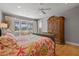 Bedroom featuring wood floors, large windows, and a decorative bedspread at 5373 Anthony Ln, Sarasota, FL 34233